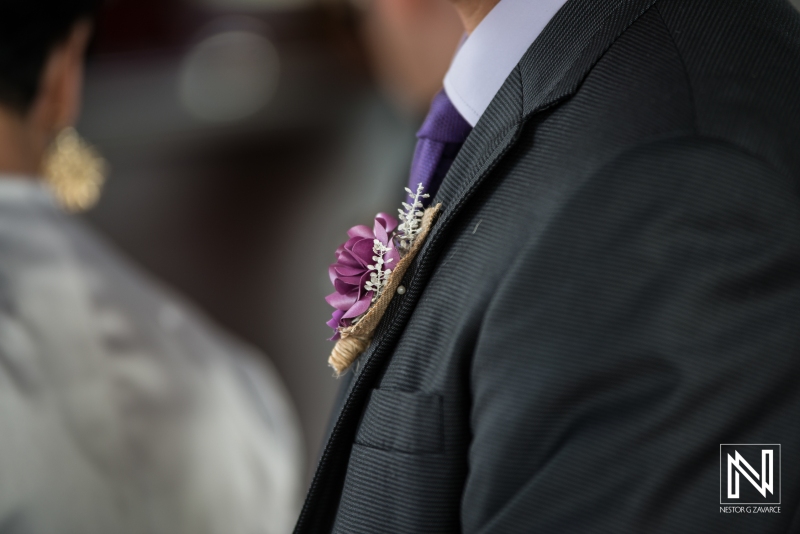 Groom boutonniere with purple flowers