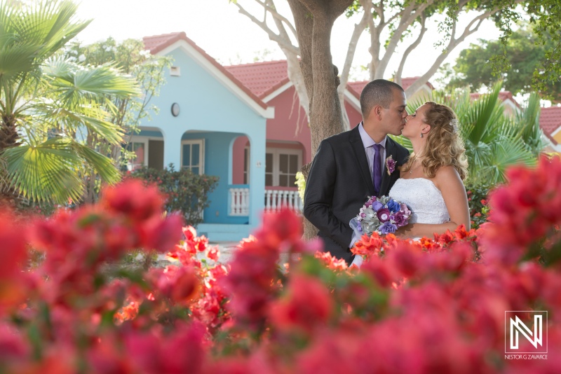 Bride and groom kissing photoshoot  with flowers