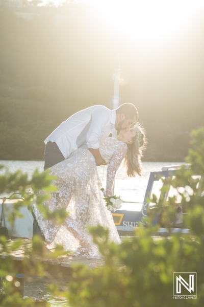 Bride and groom kiss photoshoot on the pier