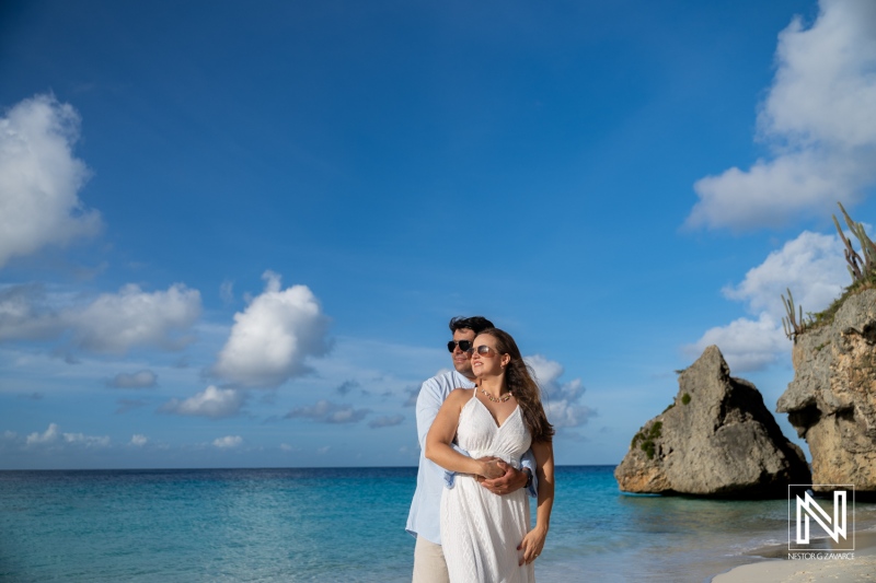 Couple enjoys trash the dress photoshoot at Cas Abao Beach in Curacao during sunny afternoon