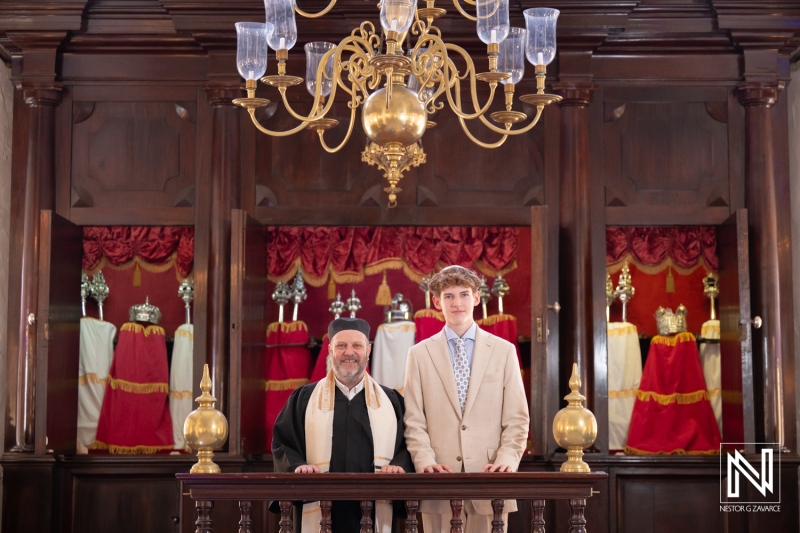 Bar Mitzvah celebration at Mikve Israel-Emanuel Synagogue in Curacao with a young man and a rabbi