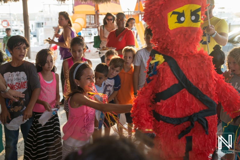 Celebrating a birthday in Curacao with a colorful piñata and joyful children engaged in festive activities