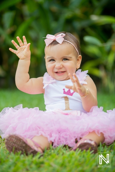 Celebrating a joyful birthday in Curacao with a happy toddler in a pink tutu and a big smile