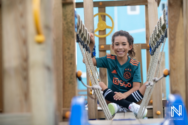 Celebrating a birthday in Curacao with joy and fun at the playground, capturing a special moment of laughter and friendship