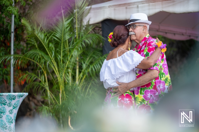 Celebrating a joyful birthday in Curacao with traditional attire and lively dancing amidst lush tropical scenery