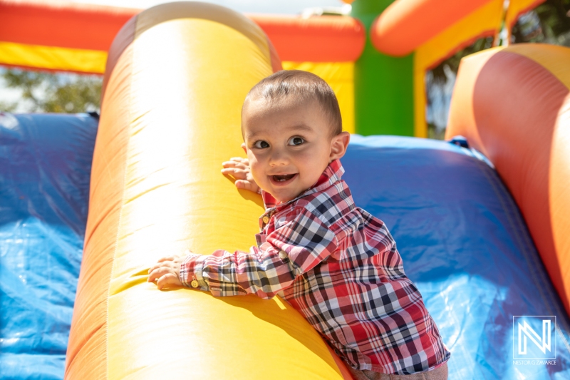 Child enjoying birthday celebration at a bouncy castle in Curacao during sunny weather