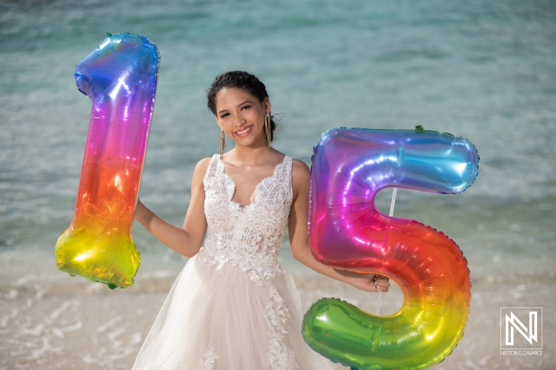 Girl celebrates her 15th birthday on the beautiful beaches of Curacao with vibrant balloons and a joyful smile