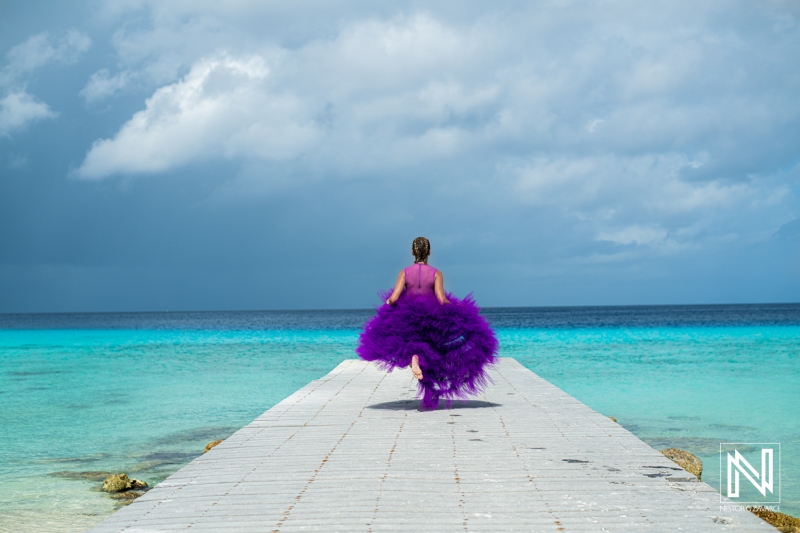 Vibrant birthday celebration on a Curacao pier with colorful dress under the Caribbean sky