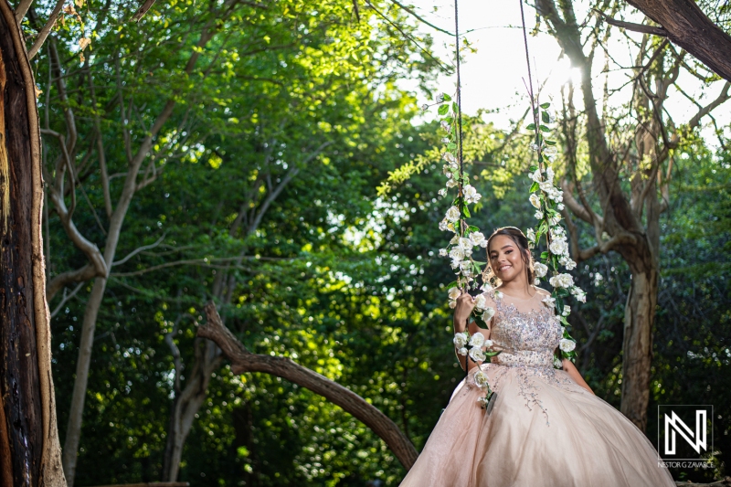 Celebrating a birthday in Curacao with a beautiful outdoor swing adorned with flowers and greenery