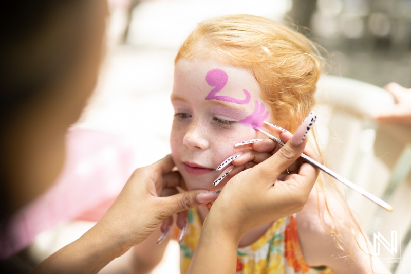 Celebration of a child's birthday in Curacao with vibrant face painting and joyful moments