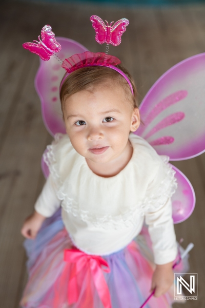 Celebrating a birthday with colorful butterfly decorations in Curacao during a joyful kids' party