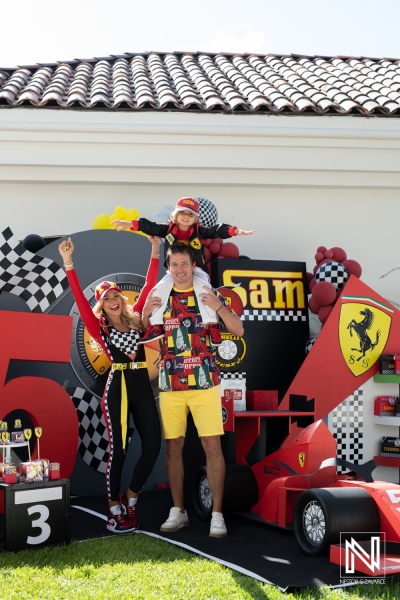 Celebrating a birthday in Curacao with a racing theme featuring a young boy in a red Ferrari outfit alongside family members