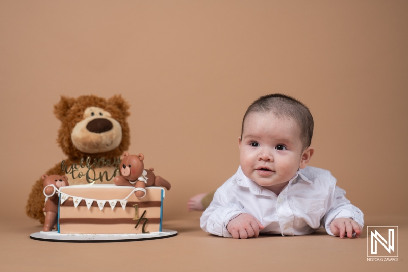 Celebrating a first birthday with a cute baby boy in Curacao, featuring a bear-themed cake and adorable decorations