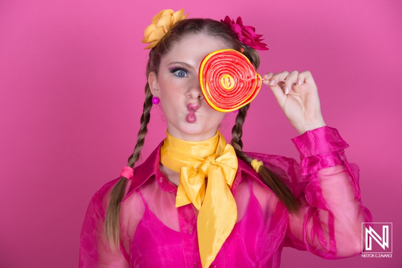 Colorful girl with a lollipop poses joyfully in a vibrant setting, showcasing playful fashion and bright expressions in Venezuela