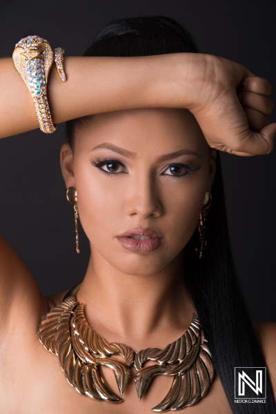 Elegant model showcases unique jewelry design with a striking expression in a professional studio setting in Curacao