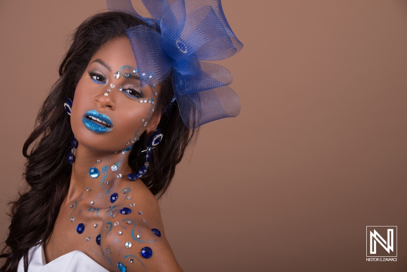 Unique beauty portrait showcasing vibrant blue makeup and decorative accessories in a studio setting inspired by the culture of Curacao