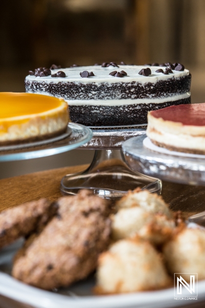 Enjoying a selection of delicious desserts at a cafe in Curacao during a vibrant afternoon gathering with friends