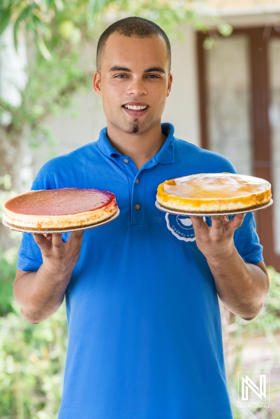 Delightful dessert display in Curacao with two vibrant cakes held by a smiling individual