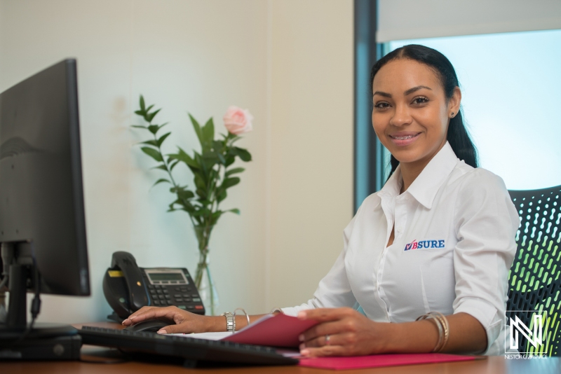 Professional woman at desk in Curacao office providing customer service during daytime