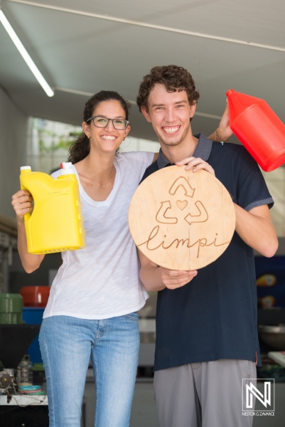 Young volunteers promote recycling efforts at a community center in Curacao, engaging locals in environmental awareness activities