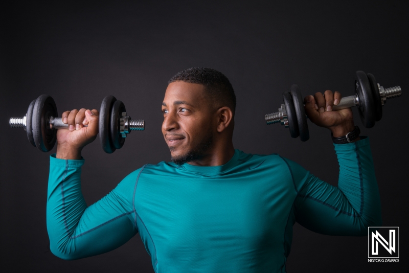 Strong individual lifting weights in a fitness studio showcasing dedication and physical strength