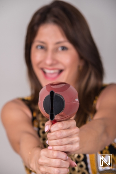 Model showcases hair styling tools in a commercial setting featuring bright colors and engaging expressions in Curacao