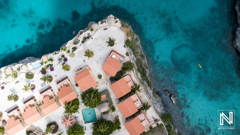 Serene beachfront resort in Curacao offers stunning views of turquoise waters and vibrant landscape during daytime