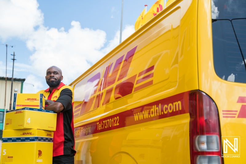 Delivery service representative preparing packages for shipment in Curacao, showcasing logistics operations and customer service at a commercial location