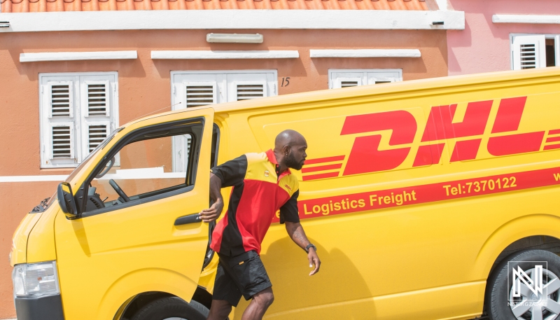 Delivery driver makes a quick stop in Curacao for logistics drop-off under bright Caribbean sun