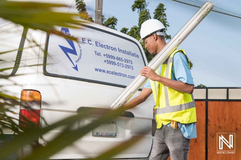 Technician prepares lighting equipment in Curacao for a commercial installation project