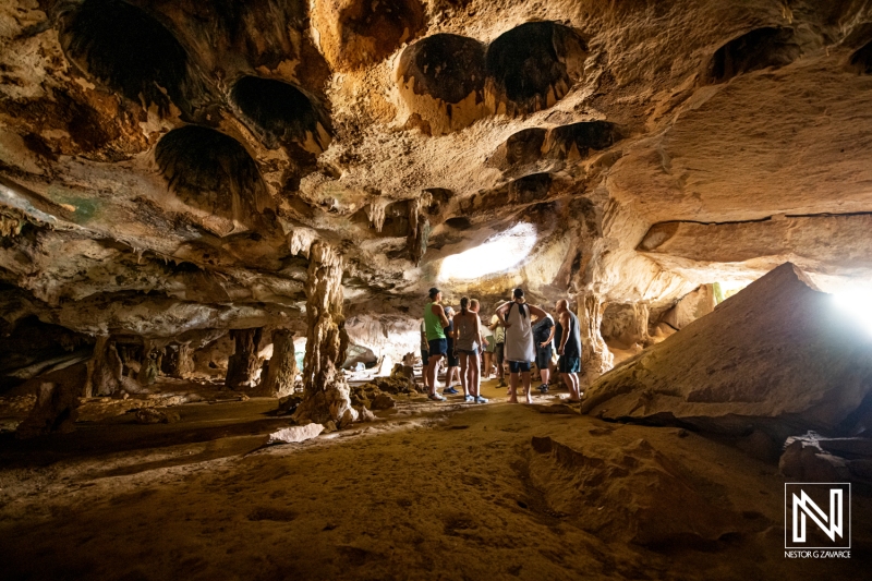 Exploring the unique natural formations in the caves of Curacao during an adventurous outing with friends in the warm tropical climate