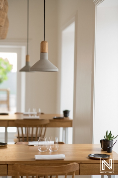 Elegant dining setup in a Curacao restaurant featuring minimalist design and natural light during afternoon hours