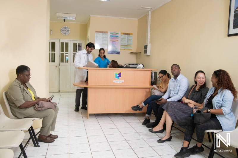 Health center reception area in Curacao with patients waiting for appointments and healthcare professionals assisting them