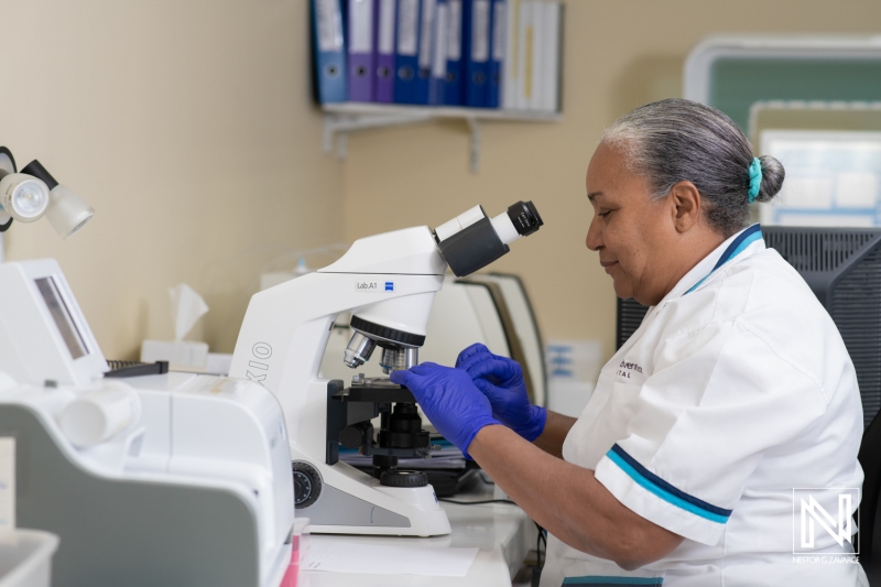 Scientist conducting research in a lab in Curacao using a microscope to analyze samples during a commercial project