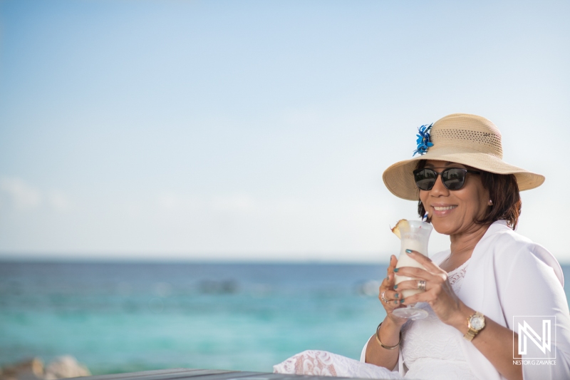 Relaxing by the beach in Curacao while sipping a refreshing drink on a sunny day