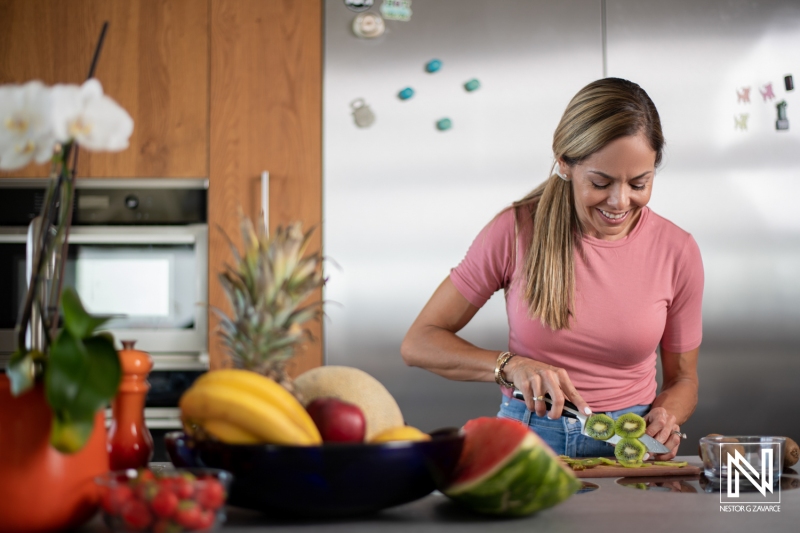 Preparing a fresh tropical fruit platter in a modern kitchen setting in Curacao while enjoying the vibrant colors of the ingredients