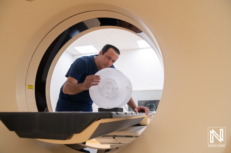 Medical technician preparing equipment for a diagnostic imaging procedure in Curacao