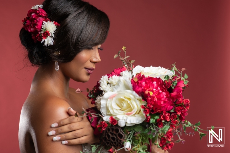 Beautiful woman holding a vibrant floral bouquet in Curacao for a commercial photoshoot during a tropical themed event