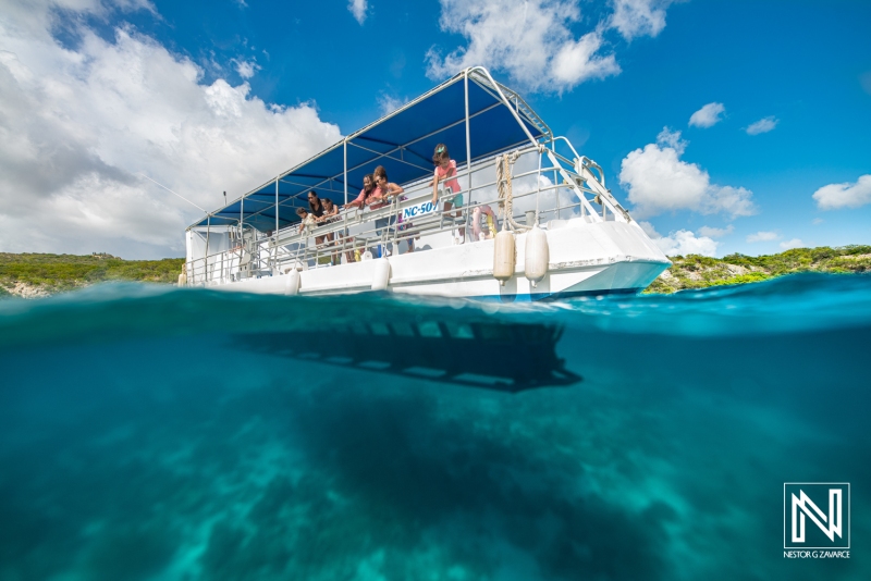 Experience the vibrant underwater world in Curacao while enjoying a boat tour with friends and family