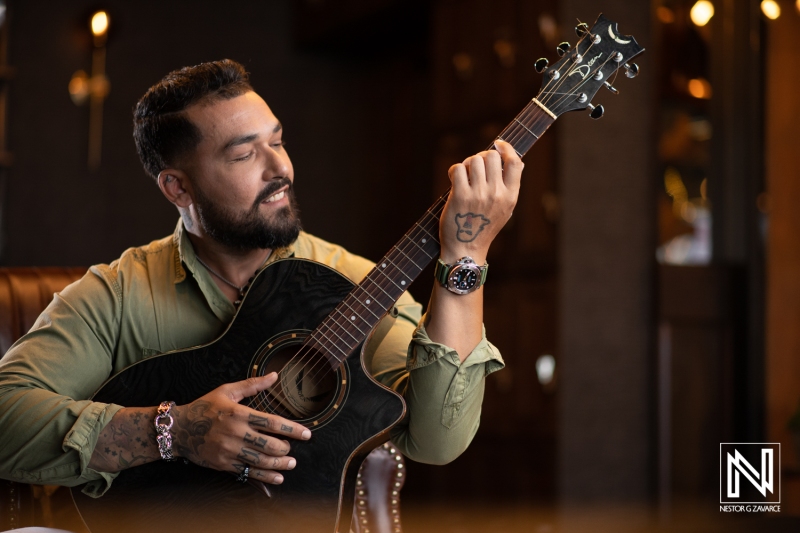 Musician plays guitar in a cozy venue showcasing the vibrant atmosphere of Curacao with elegant decor