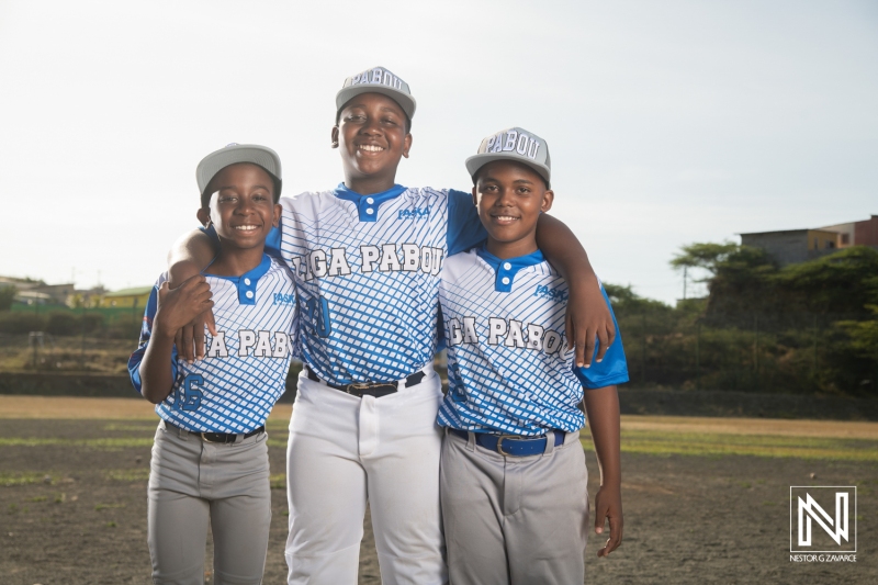 Young athletes showcase their team spirit with joyful smiles during a practice session in Curacao, emphasizing camaraderie and passion for baseball