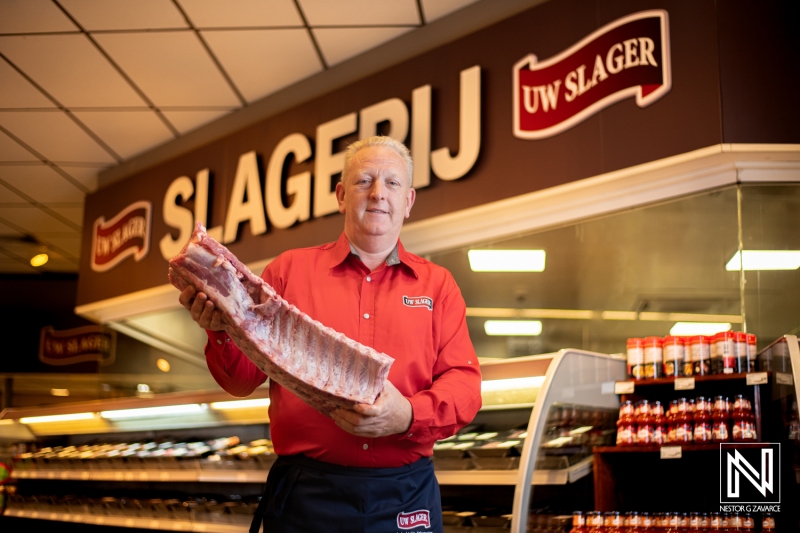 Butcher displays fresh meat selection at a local shop in Curacao showcasing quality and service