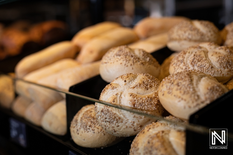 Freshly baked bread loaves on display in a commercial bakery in Curacao during daylight hours