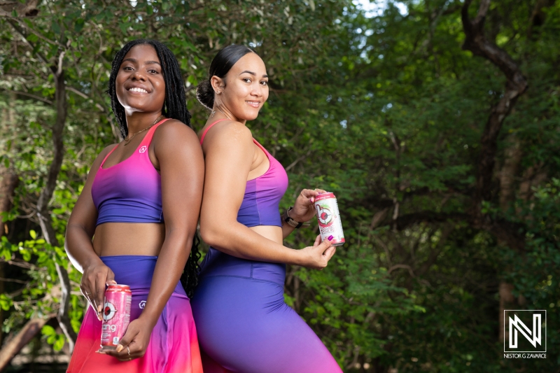 Women promote refreshing beverages in a lush outdoor setting in Curacao while showcasing athletic apparel and an active lifestyle