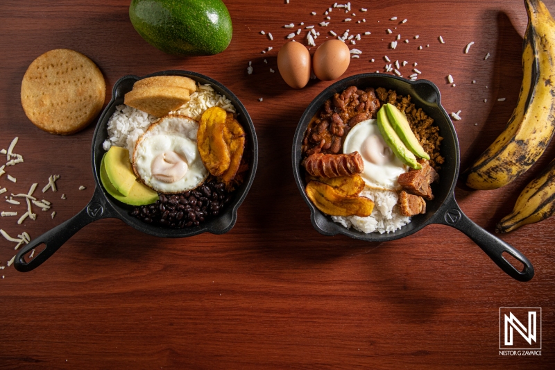 Delicious traditional dishes served in cast iron bowls featuring rice, beans, plantains, and fried eggs in Curacao