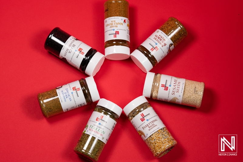 Spices and seasonings creatively arranged in a circular pattern on a vibrant backdrop showcasing local culinary flavors in Curacao