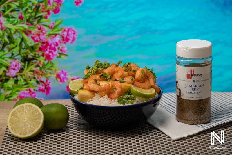 Flavorful shrimp bowl with jasmine rice and tropical backdrop featuring vibrant greens and a jar of seasoning