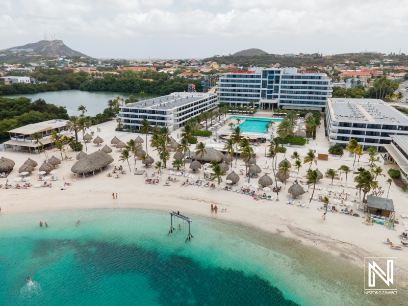 Beautiful beach resort in Curacao with stunning pool and palm trees surrounded by clear water and tropical landscape