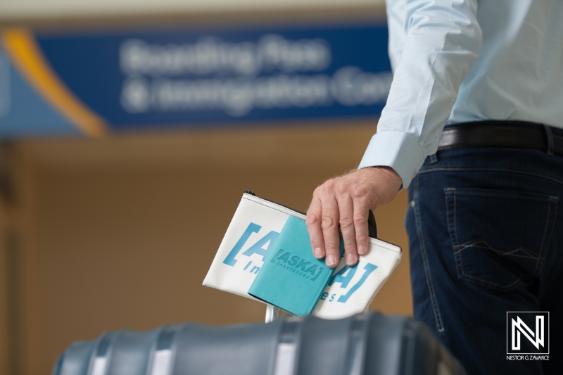 Traveler preparing for departure at the Curacao airport showcasing essential travel accessories and documents