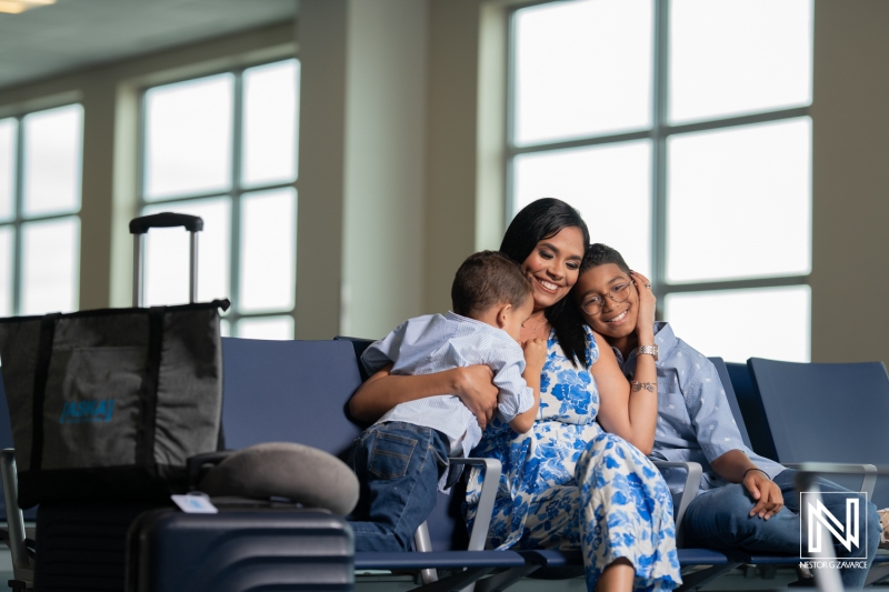 Family enjoys quality time at airport lounge in Curacao, preparing for their next vacation adventure together